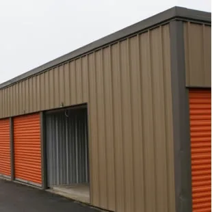 Storage building with orange roll-up doors
